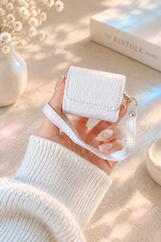 White crocodile AirPods case in hand